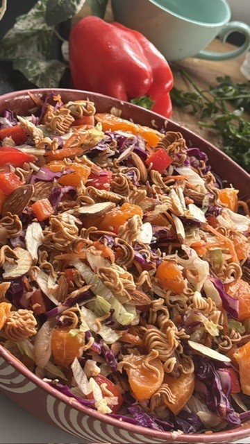Close-up of crunchy Chinese chicken salad with mandarins, almonds and noodles