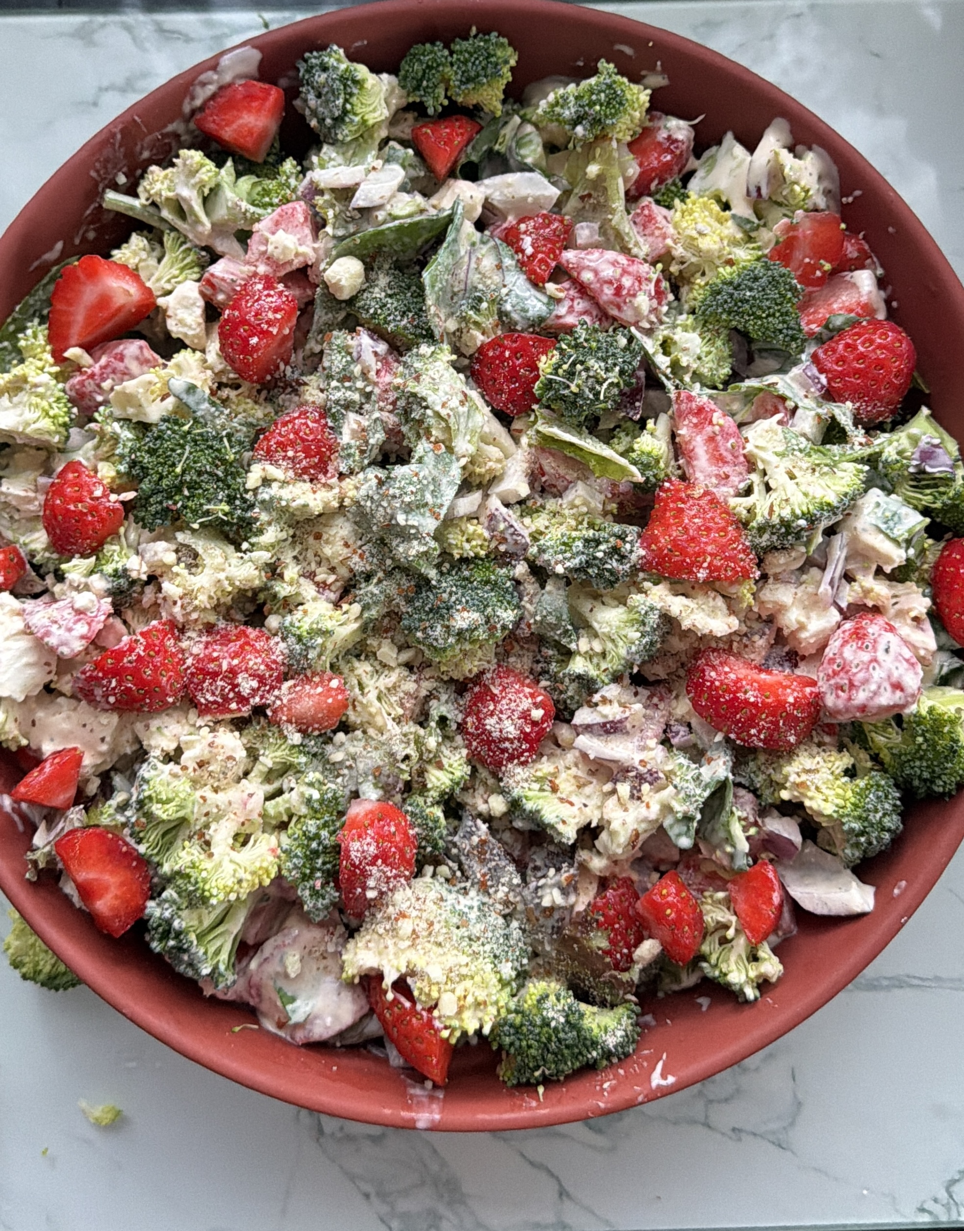 Close-up of creamy broccoli and strawberry salad